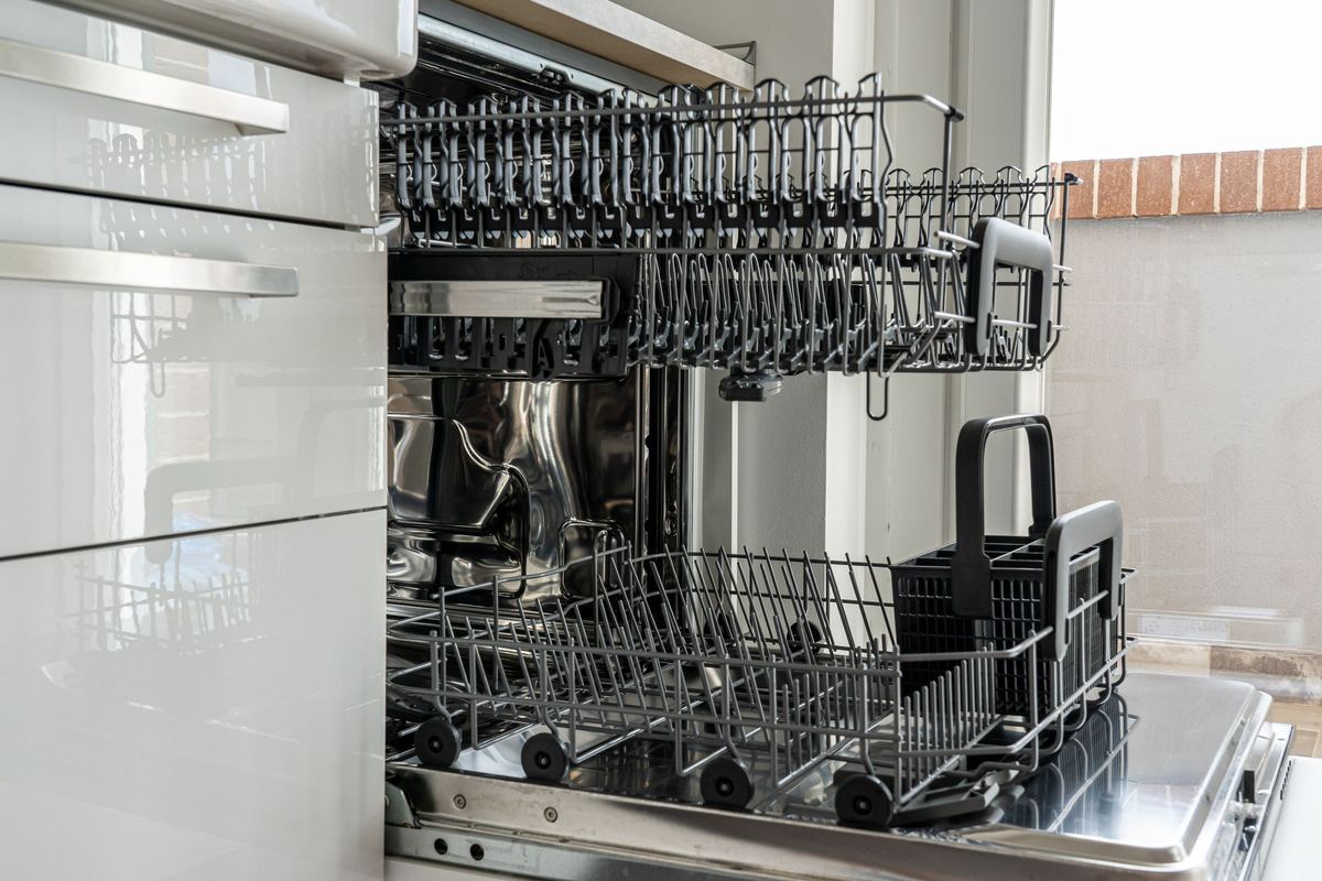 Open dishwasher with its racks pulled out