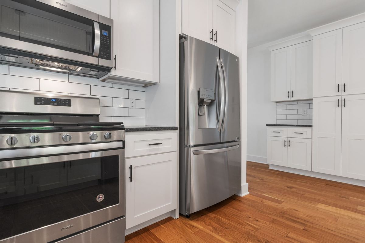 Stainless steel French-door fridge in a white kitchen
