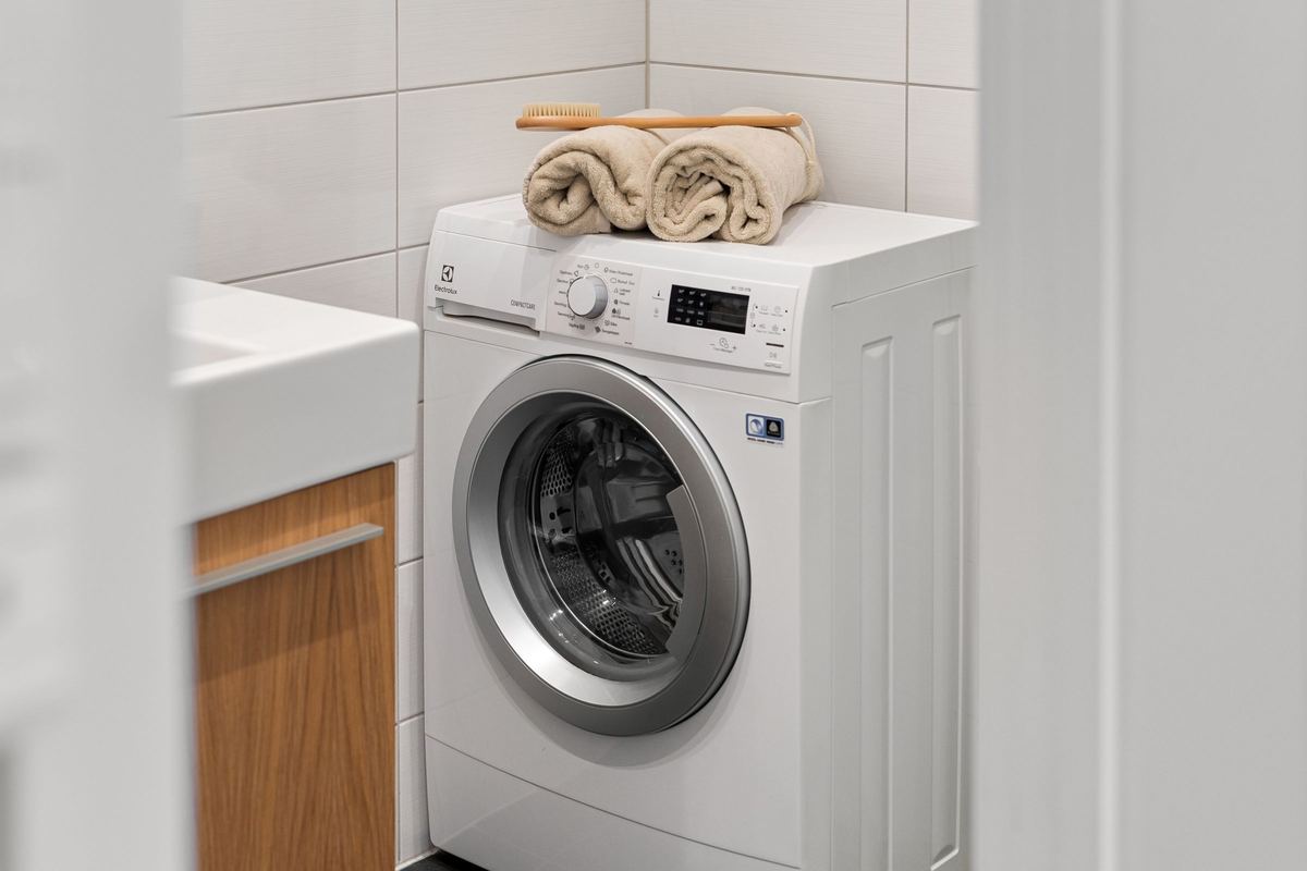 Front-loading washing machine in a bright laundry corner