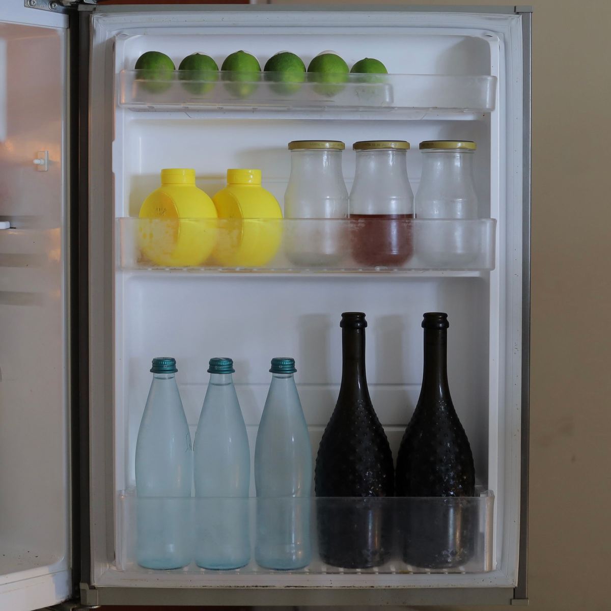 Inside an open fridge showing shelves and door racks