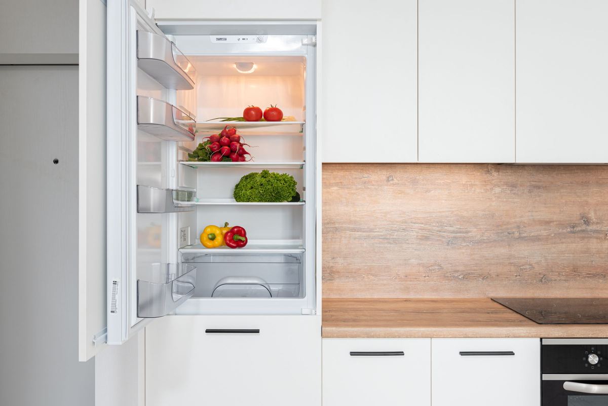 Open fridge with shelves of fresh produce
