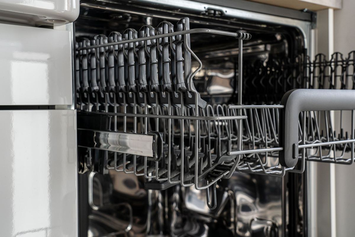 Close-up of dishwasher racks inside an open dishwasher