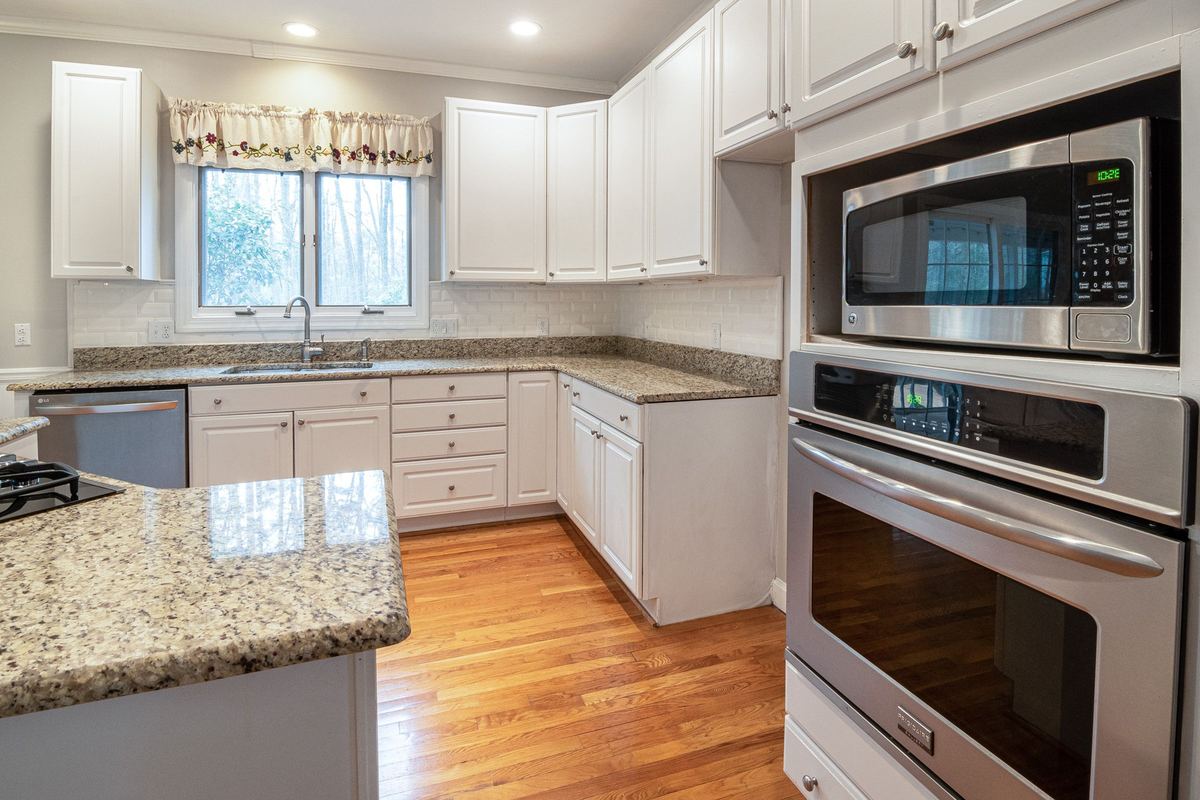 Kitchen with a built-in microwave above a wall oven