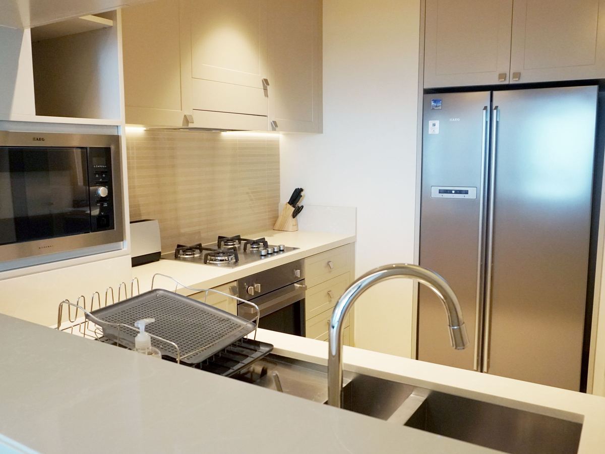 Kitchen with a stainless steel side-by-side fridge and built-in microwave