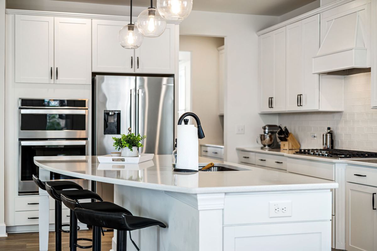 Bright kitchen with a double wall oven and stainless steel fridge