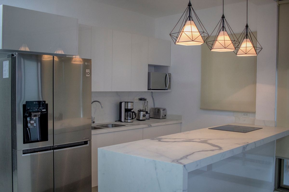 Modern kitchen with a stainless steel fridge and induction hob