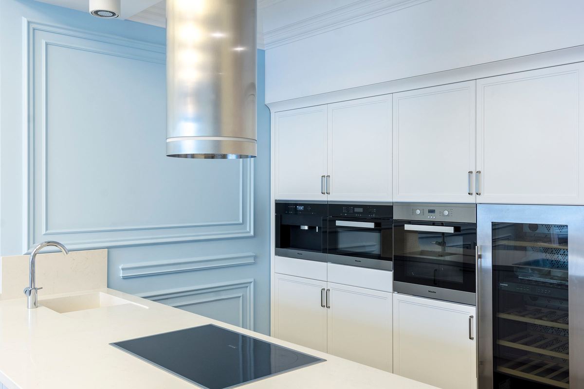 Built-in ovens and a wine fridge in a white kitchen