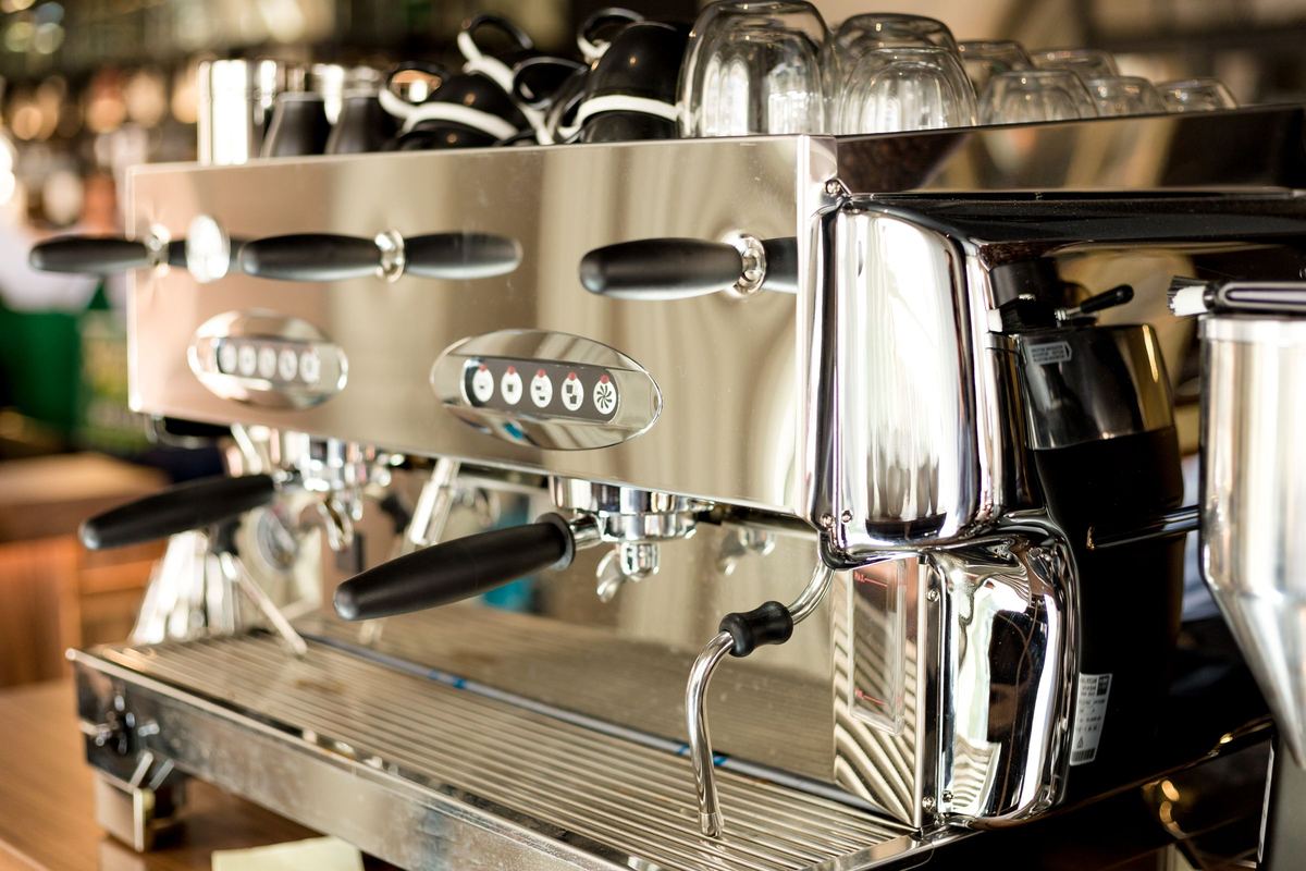 Chrome espresso coffee machine with group heads and steam wands