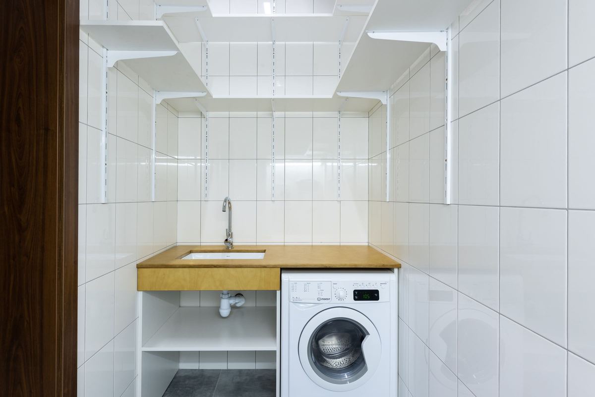 Front-loading washing machine installed under a laundry counter